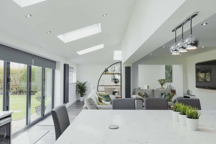 Dark roller blinds on white walls in living room