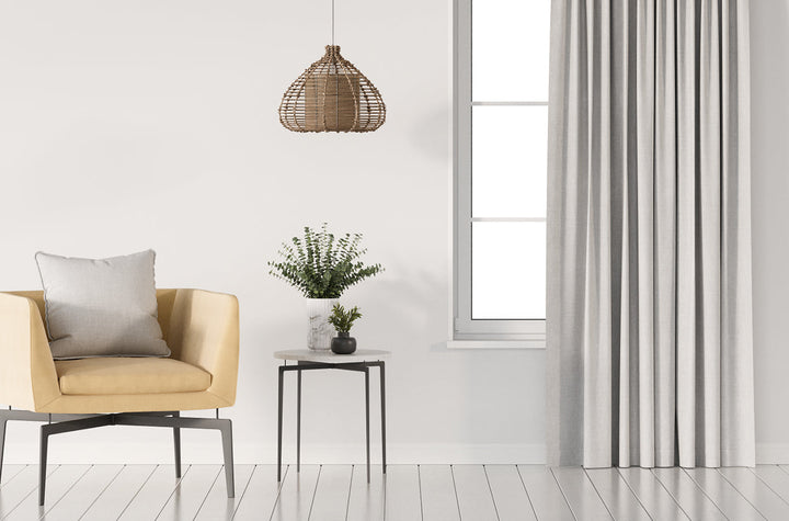 Grey blockout curtains in living room with yellow chair