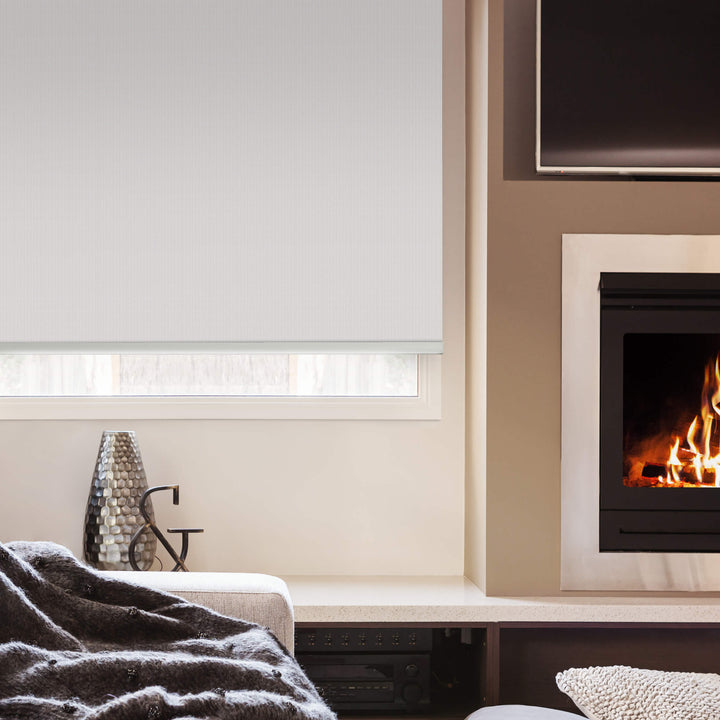 White roller blinds in living room with fireplace