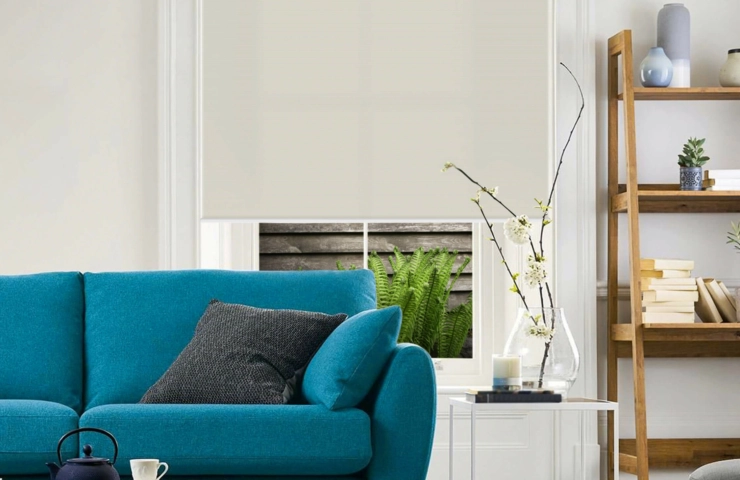 White roller blinds in room with blue couch and decor