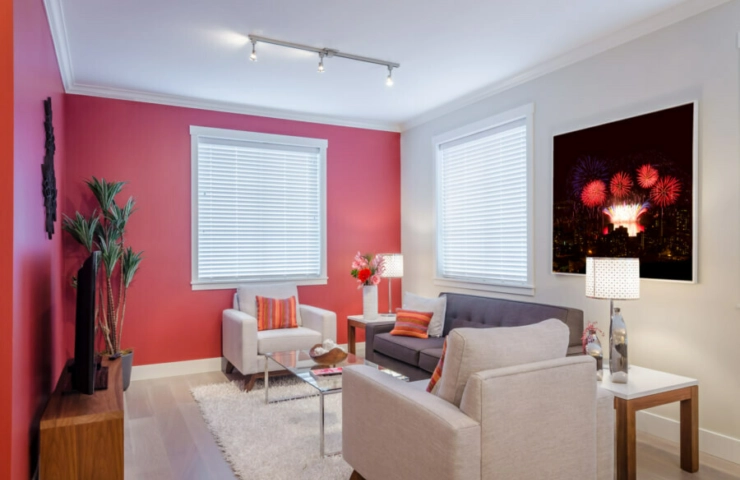 White venetian blinds on red wall in lounge room 1