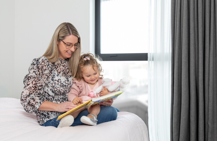 Custom curtains in room with mother reading a book to toddler