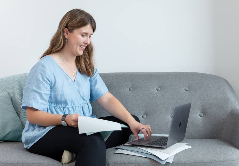 Woman looking at laptop on the couch