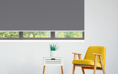 Dark Grey Roller Blockout in room with yellow chair