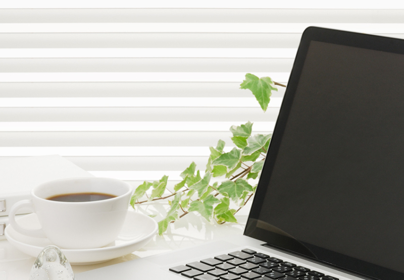 Honeycomb Light filter blinds in study space with a coffee and laptop on a desk