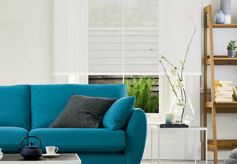 White Roller Sunscreen blind in living room with green couch